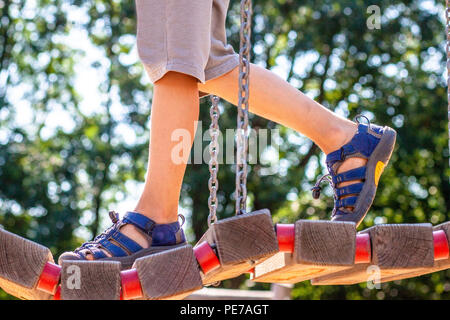 Kleine Junge mit Sandale zu Fuß über die Brücke. Stockfoto