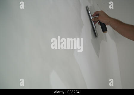 Arbeitnehmer Anwendung dekorativen Beton Putz an der Wand, auf dem flachen Fokus Stockfoto