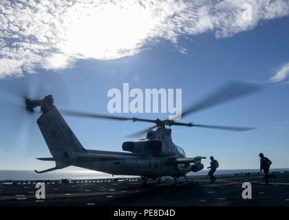 Ein AH-1Z Viper Angriffshubschrauber der Marine Medium Tilt Rotor Squadron 166 (verstärkt) wird am 23. Oktober 2015 während einer Composite Training Unit Exercise (COMPTUEX) auf dem Flugdeck des amphibischen Angriffshubschiffs USS Boxer (LHD 4) inszeniert. Die Übung umfasst die Boxer ARG, einschließlich USS New Orleans (LPD 18), USS Harpers Ferry (LSD 49) und die 13th Marine Expeditionary Unit, um die Luft-Boden-Koordination, den Seeverkehr und die Bereitschaft in Multi-Schiff- und Multi-Flugzeug-Szenarien zu testen. Stockfoto