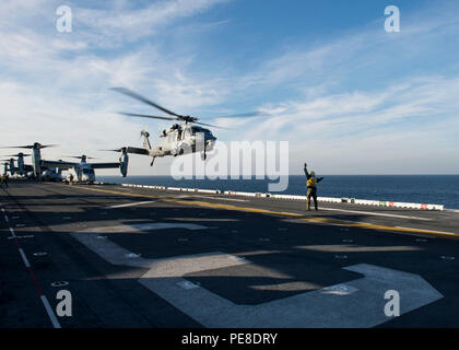 151027-N-AX638-019 Ägäis (27. Oktober 2015) Luftfahrt Boatswain Mate (Handling) 3. Klasse Donta Moore aus Houston, leitet eine SH-60 Seahawk ausziehen aus dem Flugdeck der amphibischen Angriff Schiff USS Kearsarge (LHD-3) während der Teilnahme an der Übung Egemen 2015, Okt. 27. Egemen ist eine türkische geführt und gehostete amphibische Übung zur Steigerung taktischen Fertigkeiten und Interoperabilität zwischen den Teilnehmern.  Kearsarge, eingesetzt als Teil der Kearsarge amphibische Gruppe bereit, führt Marinebetriebe in den USA 6. Flotte Bereich der Maßnahmen zur Erhöhung der US-nationalen Secu Stockfoto