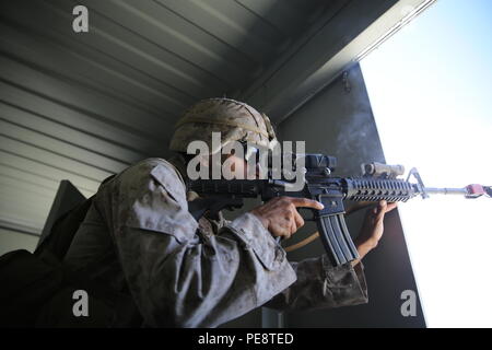 Lance Cpl. Uria Aceves, eine Infanterie Truppführer mit dem 13 Marine Expeditionary Unit, Brände in einem simulierten Feind durch ein offenes Fenster in einer langen Reihe von Raid auf PDL bekämpfen Stadt, Nov. 3, 2015 als Teil der zusammengesetzten Trainingsgerät Übung. COMPTUEX bietet die MEU ARG die Möglichkeit naval Training zu integrieren, während auch ermöglicht, Mission - spezifische Ausbildung und Bewertung für die Marines und deren Navy Counter Parts. (U.S. Marine Corps Foto von Sgt. Paris Kapern/freigegeben) Stockfoto