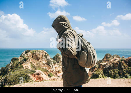 Eine junge Wanderer mit Rucksack Spaziergänge entlang der Atlantikküste in Portugal. Reise und Tourismus. Stockfoto