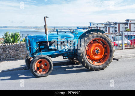 Alte blaue Fordson Major Traktor mit roten Räder in "Westward Ho!, Devon, Großbritannien Stockfoto