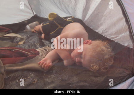 Zwei Jahre alten Jungen schlafen in eine Strandmuschel, Devon, England, Vereinigtes Königreich. Stockfoto