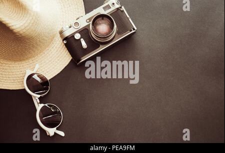 Sonnenbrille, Kamera und Hut auf grauem Hintergrund Stockfoto