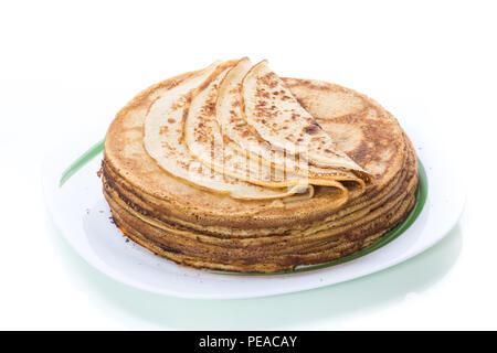 Große hohe dünne Pfannkuchen in einer Platte auf einem weißen Hintergrund Stapel Stockfoto