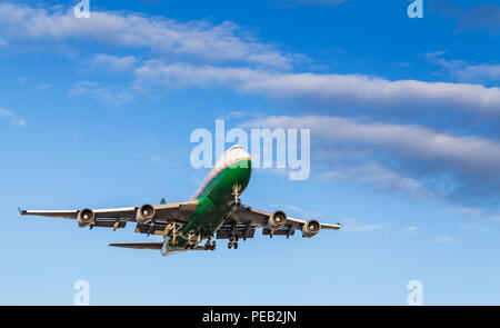 Eine grüne und weiße 747 Landung auf dem Internationalen Flughafen von Vancouver an einem sonnigen Tag. Stockfoto