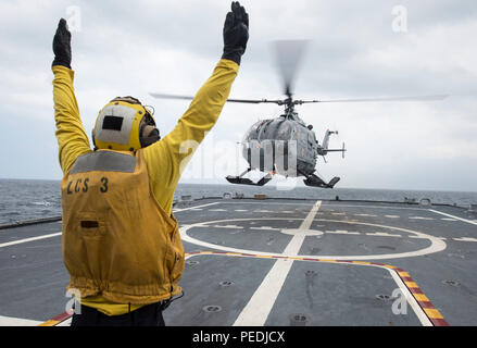 150808-N-MK 881-074 SOUTH CHINA SEA (Aug. t 8, 2015) der Bootsmann Mate 2. Klasse Manuel Gallegos, zugeordnet dem Littoral Combat Ship USS Fort Worth (LCS3), eine Messerschmitt-Bolkow-guides entfernt Blohm Bo 105 indonesische Marine Hubschrauber während ein Deck Landung Übung auf dem Flugdeck von Fort Worth im Rahmen der Zusammenarbeit flott Bereitschaft und Weiterbildung (CARAT) Indonesien 2015. CARAT ist eine jährliche bilaterale Übung Serie mit der US Navy, US Marine Corps und der bewaffneten Kräfte der neun Partner Nationen. (U.S. Marine Foto von Mass Communication Specialist 2. Klasse Joe Bischof/Freigegeben) Stockfoto