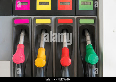 In der Nähe von verschmutzten Kraftstoff Düse in Öl Spender mit Benzin und Diesel in Service Tankstelle. Muster Benzin pumpe gun Füllung Grün Rot Gelb Pink farbenfroher Stil. Energie Stockfoto