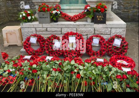 Weltkrieg eine Festveranstaltung poppy Kränze & rote Rosen rund um das Kriegerdenkmal in Hay-on-Wye, Powys Wales UK Stockfoto