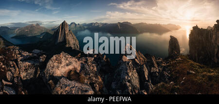 Gebirgiges panorama Querformat mit gewaltigen Fjorde während Golden Sunset in Senja, Norwegen Stockfoto