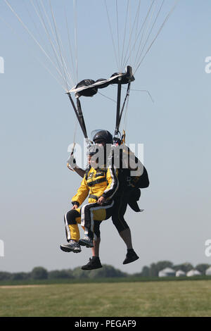 Nancy Loo, Reporter der Chicago WGN-TV-Nachrichten, führt einen Tandemsprung mit Sgt. 1. Klasse Jon Ewald, Kursleiter/Videographer, Tandem Team, U.S. Army Parachute Team, "Golden Knights' während einem Tandem Lager in Ottawa, Illinois, 12.08.12 statt. Loo war mit 13 anderen Teilnehmern, darunter ihre Tochter Aubrey, der in einem Tandemsprung mit dem Team dort teilgenommen. Teilnehmer sprang von 13.000 Fuß bei Sky Dive Chicago. Die "goldene Ritter", in Fort Bragg, N. C., Angeboten, lokale Chicago land Pädagogen, die Medien und die Regierung die Möglichkeit zu springen aus einem Flugzeug Erfahrung, rauschende Stockfoto