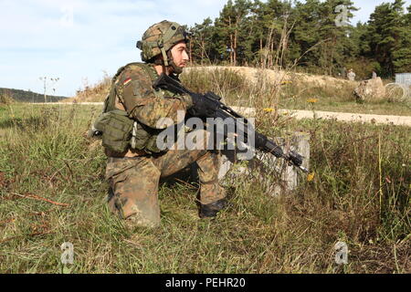 Ein Deutscher Soldat 31 Fallschirmjäger Regiment 1 Airborne Brigade Security bietet während der Durchführung eines Angriffs während der Übung die schnelle Reaktion 15 bei der US Army Joint Multinational Readiness Center in Hohenfels, Deutschland, 27.08.2007 2015. Der Zweck der Übung ist es, gemeinsame und kombinierte Ausbildung Veranstaltungen durchzuführen, um Brigade und Bataillon ebene Durchführung von Strategischen heraus - Belastung in Verbindung mit den alliierten Partner Nationen über eine zwischengeschaltete staging Basis zu bewerten. Schnelle Reaktion 15 ist der US-Armee größte kombinierte Airborne Schulungsveranstaltung in Europa seit dem Ende des Kalten Krieges. Stockfoto