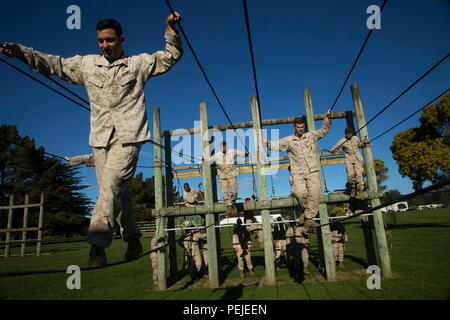 Us Marine Sgt. Matthew Russell, Links, Salden über eine seilbrücke beim Navigieren im Hindernislauf in Camp Linton, Neuseeland, während der übung Joint Assault Signale Firma Schwarz, August 17, 2015. Neuseeland Soldaten vertraut gemacht, die Marines mit ihren Parcours für körperliches Training. Die Kiwi Soldaten werden mit Batterie 161, 16 Feld Regiment. Russell ist aus Detroit, Michigan, und ein Brand support Mann mit 5 Air Naval Geschützfeuer Liaison Firma, III Marine Expeditionary Force Headquarters Group, III MEF. (U.S. Marine Corps Foto von Cpl. Isaac Ibarra/Freigegeben) Stockfoto