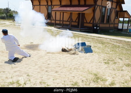 Die Besatzungsmitglieder von der Coast Guard Station Indian River in einem Lyle gun Demonstration an der Indian River Life-Saving Station in Rehoboth Beach, Delaware, Samstag, 12.08.29, 2015 teilnehmen. Die Station wurde 1876 für die Nutzung durch die Vereinigten Staaten Life-Saving Service, eine staatliche Organisation geschaffen, um die alarmierende Anzahl von Wracks an den Küsten der Vereinigten Staaten zu reagieren. Stockfoto