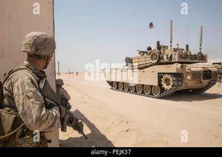 KUWAIT (28. August 2015) US-Marines mit Kilo Company, Battalion Landing Team 3. Bataillon, 1. Marineregiment, 15. Marine Expeditionary Unit, Proben urban patrouillierenden Techniken wie ein M1A1 Abrams-Panzer bietet Sicherheit bei militärischen Operationen in urbanem Gelände Training. Während der Ausbildung Marines geprobt patrouillieren durch Stadtgebiete und Sofortmaßnahmen Bohrer. Elemente des 15. MEU sind an Land in Kuwait für Erhaltung Ausbildung zu erhalten und zu verbessern die Fähigkeiten, die sie während ihrer Periode der Einsatzvorbereitenden Ausbildung entwickelt.  Die 15. MEU ist an Bord der Essex amphibische lesen begonnen. Stockfoto