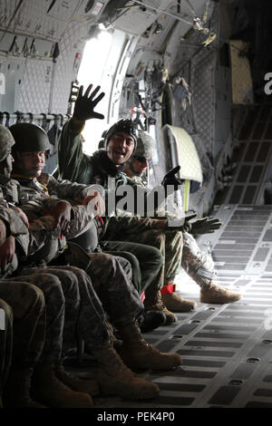 Niederländische Jumpmaster Sgt. 1. Klasse Björn Oehlers Signale sechs Minuten, bis der Sprung in einem Betrieb im Rahmen der Operation Spielzeug Fallen, mackall Army Airfield, N.C., Dez. 9, 2015. Betrieb Spielzeug Drop beginnt, wird größten kombinierten Betrieb der Welt mit sieben Partner - nation Fallschirmjäger teilnehmenden und Soldaten erlaubt, die Möglichkeit, Kindern in Not zu helfen, überall Spielwaren für den Urlaub erhalten. (U.S. Armee Foto von SPC. Josephine Carlson/Freigegeben) Stockfoto