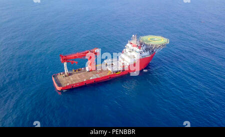 Luftbild von eine Mittelgroße rote Offshore Supply Schiff mit einem Hubschrauberlandeplatz und einem großen Kran Stockfoto