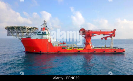 Luftbild von eine Mittelgroße rote Offshore Supply Schiff mit einem Hubschrauberlandeplatz und einem großen Kran Stockfoto