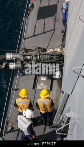 US-Seeleute an Bord der USS Arlington (LPD 24) überwachen die Betankungsarbeiten der USNS Medgar Evers (T-AKE 13) während der Replenishment-at-Sea (RAS) im Golf von Oman am 8. Januar 2016. Diese Operationen unterstützen die Kearsarge Amphibious Ready Group und die 26th Marine Expeditionary Unit, um die regionale Sicherheit zu gewährleisten, die Schiffsreife zu erhalten und die Kapazitäten für die Schifffahrt und den Treibstofftransfer zu demonstrieren, während sie im Einsatzgebiet der 5. US-Flotte tätig sind. Stockfoto