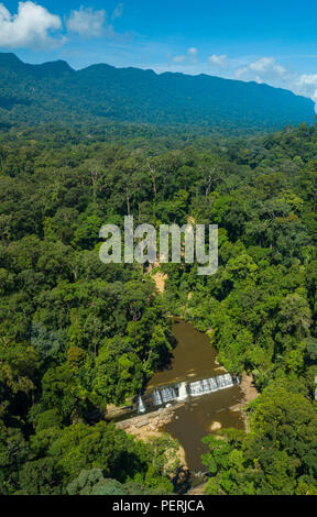 Vertikale drone Foto von Imbak fällt durch tropischen Regenwald umgeben, mit einem steilen Bergrücken im Hintergrund. Imbak Canyon, Sabah, Malaysia Stockfoto