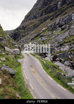 Eine schmale Straße schlängelt sich durch die Mountain pass in die Lücke der Dunloe, in der macgillycuddy Reeks Berge in der irischen Grafschaft Kerry gelegen. Stockfoto