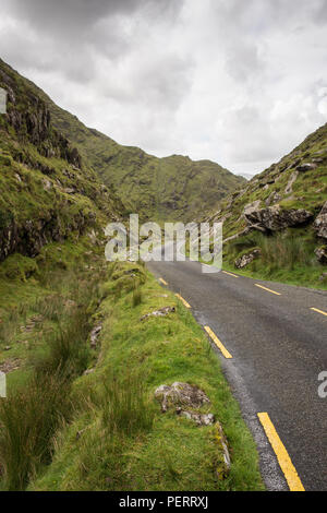 Eine schmale Straße schlängelt sich durch die Mountain pass Ballaghbeama Gap in der macgillycuddy Reeks Berge der irischen Grafschaft Kerry. Stockfoto