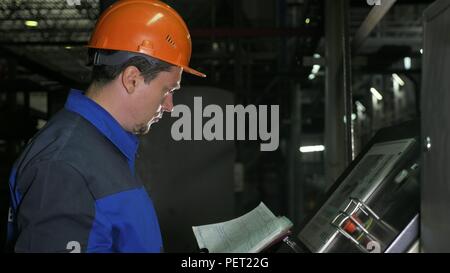 Betreiber Kontrollfeld der Fertigungsstraße. Herstellung von Wasserleitungen aus Kunststoff Fabrik. Prozess, in dem die Kunststoffe an der Werkzeugmaschine mit der Nutzung von Wasser- und Luftdruck. Stockfoto