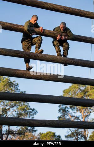 Zwei Rekruten aus Platoon 1024, Alpha Company, 1. Rekrut Training Battalion, klettern am 8. Februar 2016 auf einem Confidence Course Hindernis im Marine Corps Recruit Depot Parris Island, South Carolina. Der Kurs mit 15 Hindernissen entwickelt Balance, Koordination, mentale Belastbarkeit und körperliche Kraft im Rahmen des 13-wöchigen Trainingsprogramms. Etwa 19.000 Rekruten nehmen jährlich teil, um United States Marines zu werden. Alpha Company ist für den 15. April 2016 geplant. Stockfoto