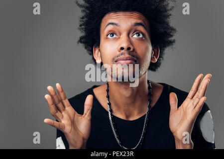 Gott, Bitte. Kopieren Sie Platz. Körpersprache. Afrikanische männliche Kursteilnehmer, Seite mit erfreulichen Ausdruck, in der Hoffnung auf gute Noten auf Test. Stockfoto