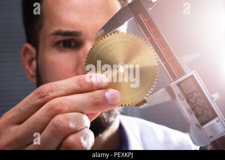 Close-up von der Größe eines Menschen Hand Messgetriebe mit digitalen elektronischen Messschieber Stockfoto