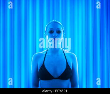 Frau tragen Schutzbrille Solarium. Stockfoto