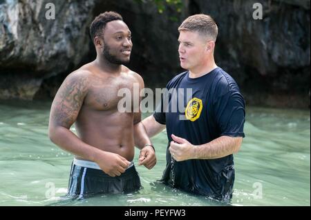 160214-N-EH 218-200 APRA HARBOR, Guam (Feb. 14, 2016) - der Gunner Mate Seemann Oshane Shirley, von Spanish Town, Jamaika, bereitet von Leutnant Stephen Brown, getauft zu werden, Kaplan in den geführten zugeordnet - missile Cruiser USS Mobile Bay (CG53). Eine Bekämpfung - bereit Kraft kollektiven maritime Interessen zu schützen, Mobile Bay, der stennis Streik Gruppe zugeordnet ist, arbeitet als Teil der Großen Grüne Flotte in regelmäßigen Western Pacific Bereitstellung. (U.S. Marine Foto von Mass Communication Specialist 2. Klasse Ryan J. Batchelder/Freigegeben) Stockfoto