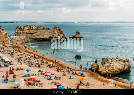 LAGOS, PORTUGAL - 28. AUGUST 2017: Touristen Spaß im Wasser, Entspannen und Sonnenbaden in Lagos Stadt am Strand am Meer von Portugal Stockfoto