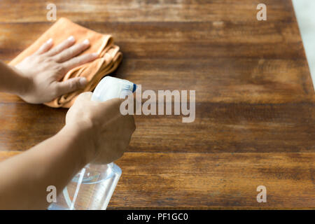 Kellner Reinigung der Tabelle mit Desinfektionsmittel Spray Stockfoto