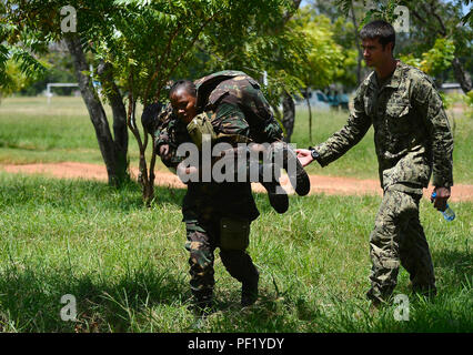 Ein Mitglied der tansanischen Volk Defence Force Praktiken trägt als Teil der medizinische Teil der humanitären Minenräumung Level 1 Training bewirtet durch TPDF mit Unterstützung von Combined Joint Task Force-Horn von Afrikas die Beseitigung von Explosivstoffen Mobile Unit 1, in Dar-es-Salaam, Tansania, Jan. 17, 2016. Hospital Corpsman 2. Klasse Isgar, EOD Mobile Unit 1, erleichtert eine theoretische Schulung und praktische Übungen die Fähigkeit des TPDF Verletzungen im Bereich verarbeiten zu können, zu erhöhen. (U.S. Air Force Foto von Tech. Sgt. Dan DeCook) Stockfoto