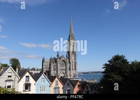 Cobh farbenfrohen Häuser und die prächtige Kathedrale und sieht aus, als es auf den Dächern der Häuser sitzt, genießen Sie die irischen Sommer Sonne. Stockfoto