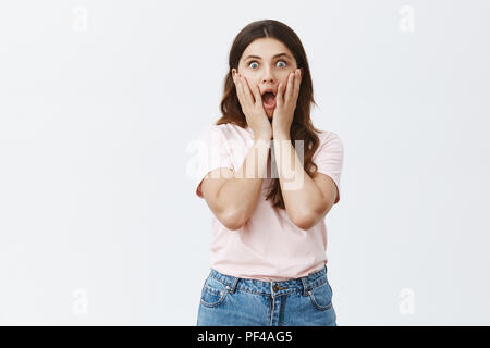 Omg Summer Sale in der Nähe. Portrait von geschockt und sprachlos attraktive Freundin aufgeregt in Rosa t-shirt fallen Kiefer von Verwunderung, Hände auf Gesicht und starrte erstaunt an Kamera Stockfoto