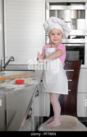 Wunderschöne kleine Mädchen lernt eine Mahlzeit in der Küche zu kochen Stockfoto