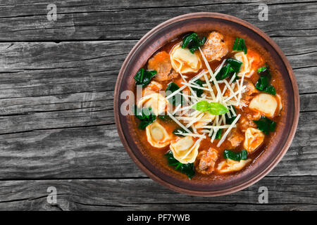 Tortellini Suppe mit italienischer Wurst, Spinat, Tomaten, Parmesankäse, Draufsicht Stockfoto