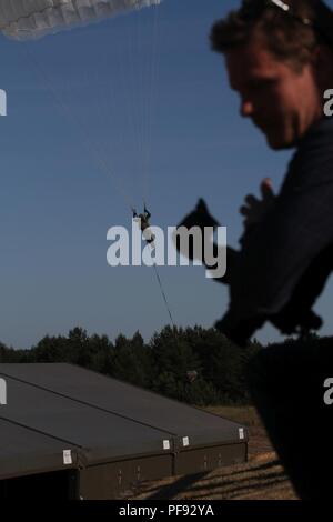 Ein polnischer Soldat mit dem 6 Airborne Bataillon, 6 Airborne Brigade aus Krakau, Polen, bereitet die sicher zu landen, während knapp die Vermeidung einer Struktur an Land Kräfte Training Center Drawsko, Polen, 7. Juni 2018 Während Sabre Streik 18. Sabre Streik 18 ist der achte Iteration des langjährigen US-Army Europe - LED-kooperative Ausbildung übung, die Interoperabilität zwischen den Verbündeten und Partnern in der Region zu verbessern. (Michigan Army National Guard Stockfoto