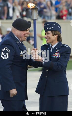 Senior Master Sgt. Israel Del Torro, erste Fackel Barriere für die DoD Krieger Spiele, Hände, die Fackel zu Generalleutnant Gina Grosso, Stellvertretender Chef des Stabes für Manpower, Personal und Dienstleistungen, innen Falcon Stadion während der eröffnungsfeier dieser Jahre Krieger Spiele, 2. Juni 2018. Der Krieger Spiele, statt Juni 1-9, 2018 an der US Air Force Academy in Colorado, sind die PARALYMPISCHEN - style Wettbewerb für die Verwundeten und verletzten Service Mitglieder aus allen US-amerikanischen Filialen der Service und sind in diesem Jahr Mannschaften aus dem Vereinigten Königreich Streitkräfte, die Australian Defence Force und der kanadischen Streitkräfte. Stockfoto