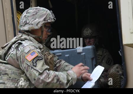 (Von links) Staff Sgt. James Ahn, eine Beseitigung von Explosivstoffen team leader mit 49Th Ordnance Company, Fort Campbell, Ky., und sein Team Mitglied, Sgt. Erin Dobbins, überprüfen Sie die Informationen auf der Bedieneinheit für den talon Roboter, während die 2018 Ordnance Tiegel auf Fort A.P. Hill, Virginia, 4. Juni 2018. EOD-Teams sind für die Maßnahmen bewertet und die damit verbundenen Aufgaben zur Unified land Operationen zu EOD unterstützen zu beseitigen und/oder explosiven Bedrohungen zu reduzieren. Die Ordnance Tiegel ist so konzipiert, dass Teamwork Soldaten und ihre Fähigkeiten zum kritischen Denken zu prüfen, während Sie technische Lösungen für echte anwenden Stockfoto