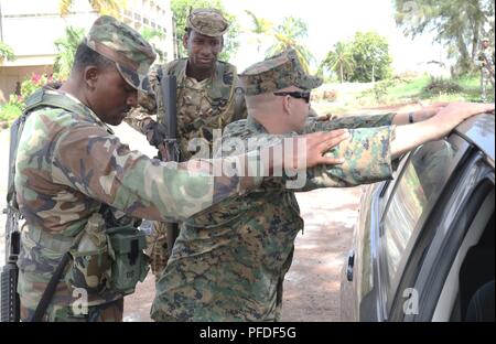 Marine Staff Sgt. James W. Warren, eine militärische Polizeioffizier mit der 2. Strafverfolgung Bataillon, II Marine Expeditionary Force, Rollenspiele einen Drogenhändler mit Mitgliedern der Grenada besonderen Service Einheit während Tradewinds 2018 Juni 6, 2018, in Basseterre, St. Kitts. Tradewinds bietet den teilnehmenden Ländern die Gelegenheit, Sicherheit und Disaster Response Fähigkeiten zu verbessern. Stockfoto