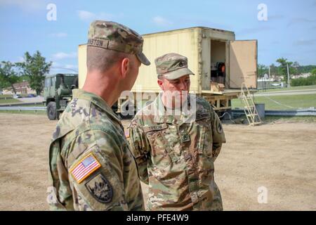 CAMP ÄSCHE, Mich-Command Sgt. Maj. Tyson Johnston, der 81St Truppe Befehl älterer Soldat Führer, fragen Staff Sgt. Mathew Tiblow der 139 unterstützt Unternehmen 2 Bataillon 150 Field Artillery Regiment, während auf die tägliche Arbeit ihrer Wartung zelt Funktionen und Arbeitsbelastung einen Befehl besuch Juni 7, 2018 in Camp Äsche, mich der Pflege Zelt läuft 24 Stunden am Tag notwendigen Support Einheiten während ihrer jährlichen Schulungen zu Feld zur Verfügung zu stellen. (Indiana National Guard Stockfoto