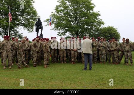 Fallschirmjäger der 82nd Airborne Division und anderen militärischen Einheiten hören Col (Ret) Kenneth Nightingale am Eisen Mike Memorial Juni 5, 2018 außerhalb von Sainte Mere Eglise, Frankreich. Nachtigall die Fallschirmjäger und Soldaten, über die Maßnahmen, die von der 82nd Abn ausgebildet. Div. fallschirmjäger während des D-Day und die folgenden Tage. Stockfoto