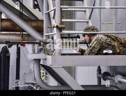 Ozean) Juni 4, 2018 - Marine Corps Lance Cpl. James Driscoll nach Lima Company, Bataillon Landung Team 3/1, Scout Sniper Platoon zugeordnet, schaut durch den Anblick eines M107 SASR während eines simulierten Strait Transit an Bord Wasp-Klasse amphibisches Schiff USS Essex (LL 2) Während composite Trainingsgerät Übung (COMPTUEX). COMPTUEX ist die letzte Übung vor der Bereitstellung, dass der kombinierte Essex Amphibious Ready Group (ARG) und 13. der Marine Expeditionary Unit (MEU) Fähigkeiten militärische Operationen auf See und Projekt power zu leiten an Land in der kommenden Einsatz im Sommer 2018 bescheinigt. Stockfoto