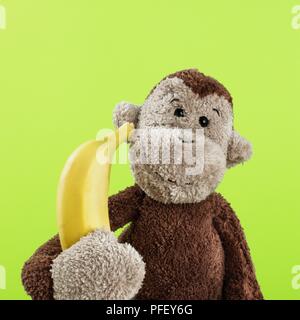 Plüschtier, Affe mit Banane Stockfoto