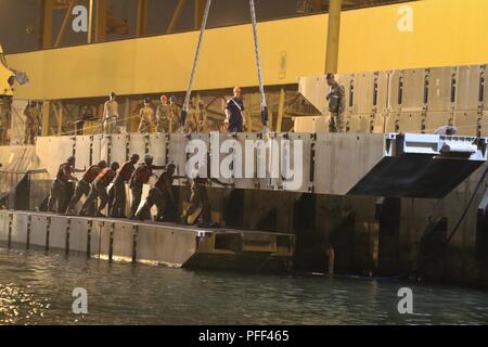 SHUIABA PORT, Kuwait - Mitglieder der 331 Transport Unternehmen arbeiten mit der 38Th Sustainment Brigade der Lastkahn Derrick Kran verwenden, um Zeichenfolgen der Internationalen Organisation für Normung (ISOPAK) Module in den Hafen, so dass Sie den Roll-on/Roll-off-Entlastung für die Logistik-über-die-Shore-Mission während Nautische Horizont 2018 Hoist. Nautische Horizont 2018 ist eine 2-stufige U.S. Army Central Stockfoto