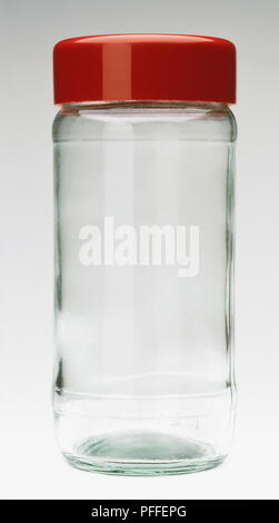 Eine leere klar Glas Glas mit rotem Deckel Stockfoto